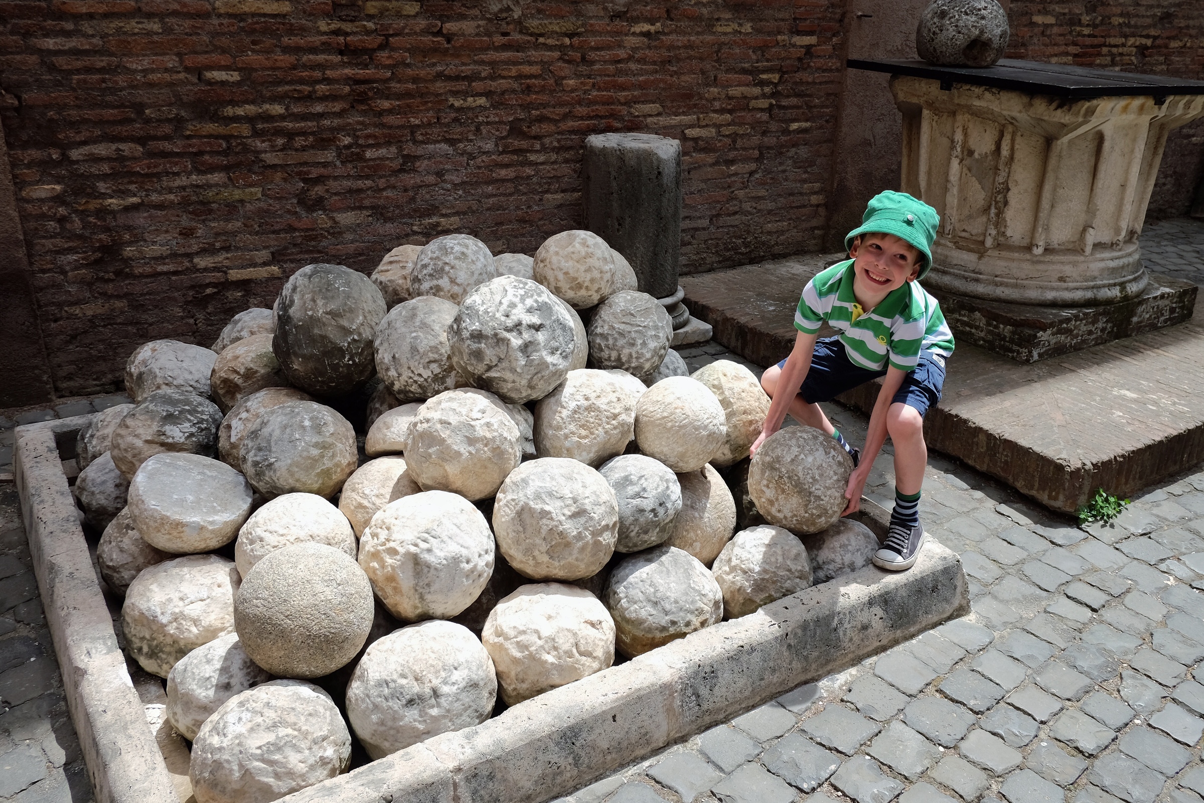 Rowan trying to lift a catapult rock at Castel Sant’Angelo.