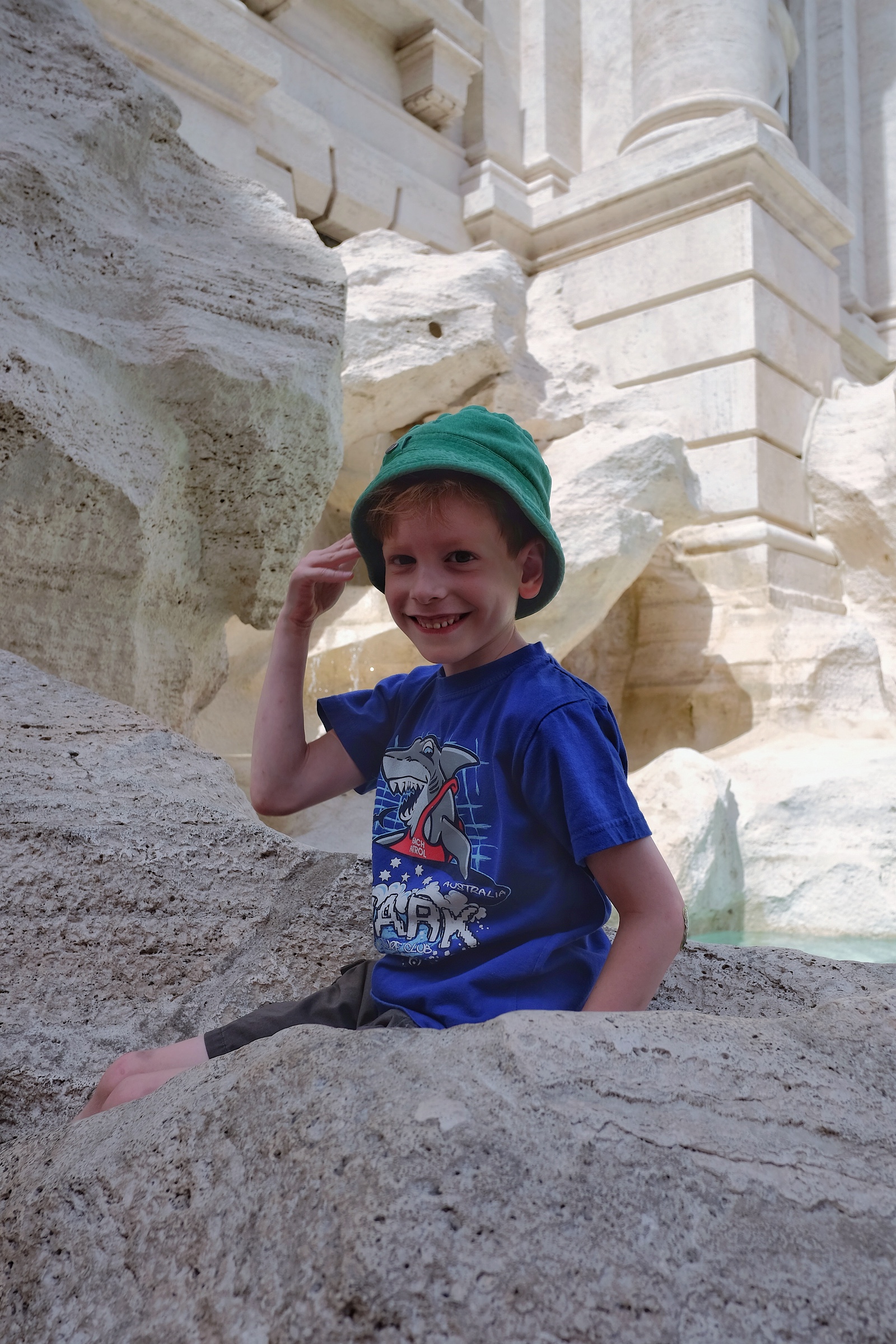 Rowan throwing a coin in to the Trevi Fountain.